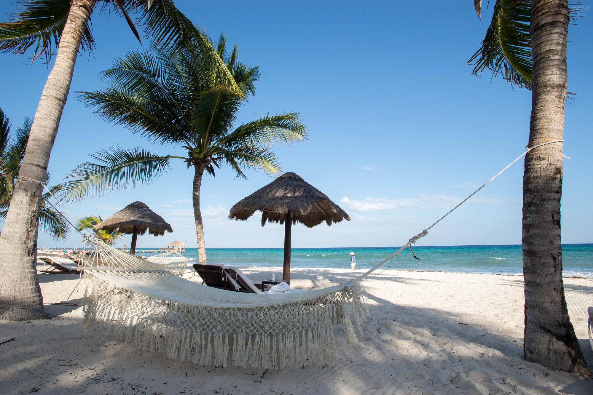 The peaceful beach with hammocks at Le Reve Boutique Beachfront Hotel