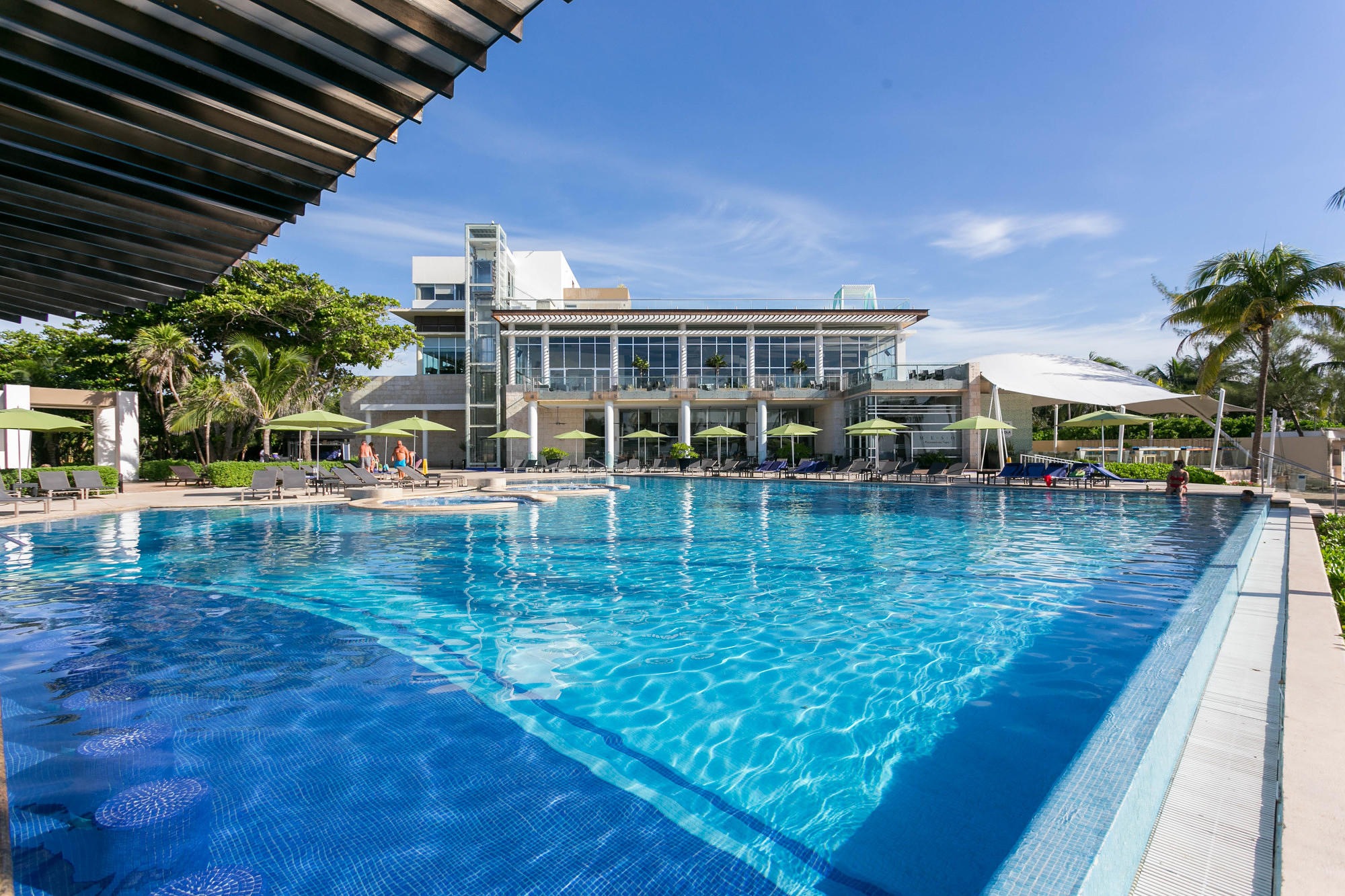 The pool and swim-up bar at The Fives Azul Beach Resort