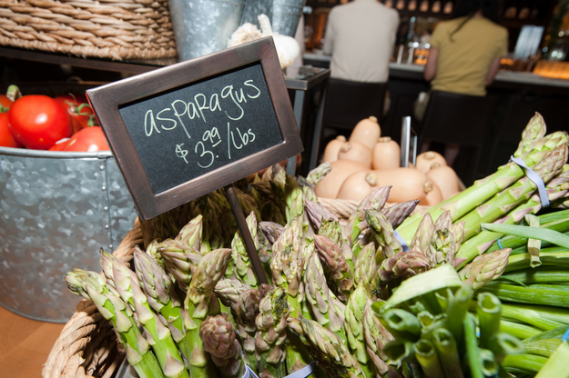 Asparagus, squash, scallions, and tomatoes are all among the fresh produce for sale that decorates the Food Hall