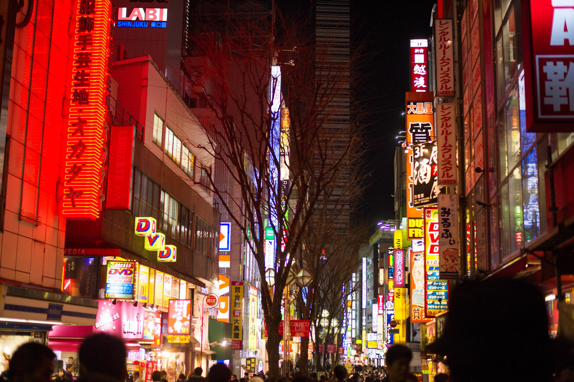 Shinjuku's neon-lit, crowded streets at night in Tokyo