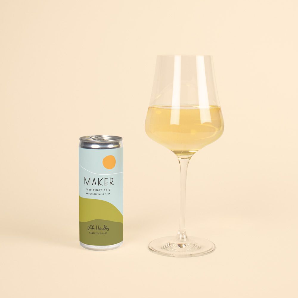 Can of Maker Pinot Gris next to a full glass of white wine