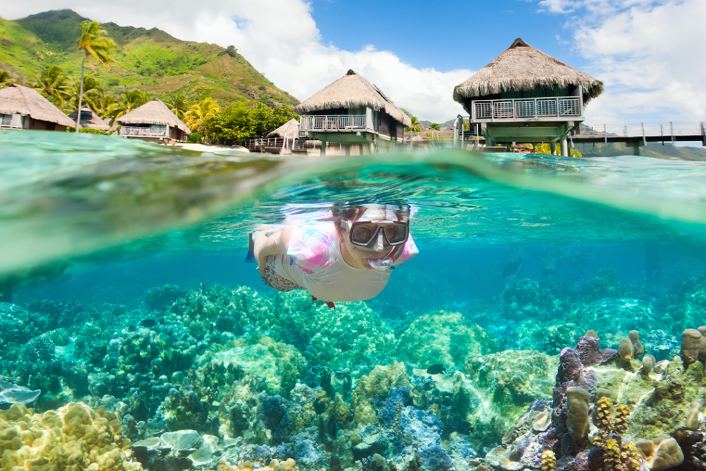 Woman snorkeling at coral reef